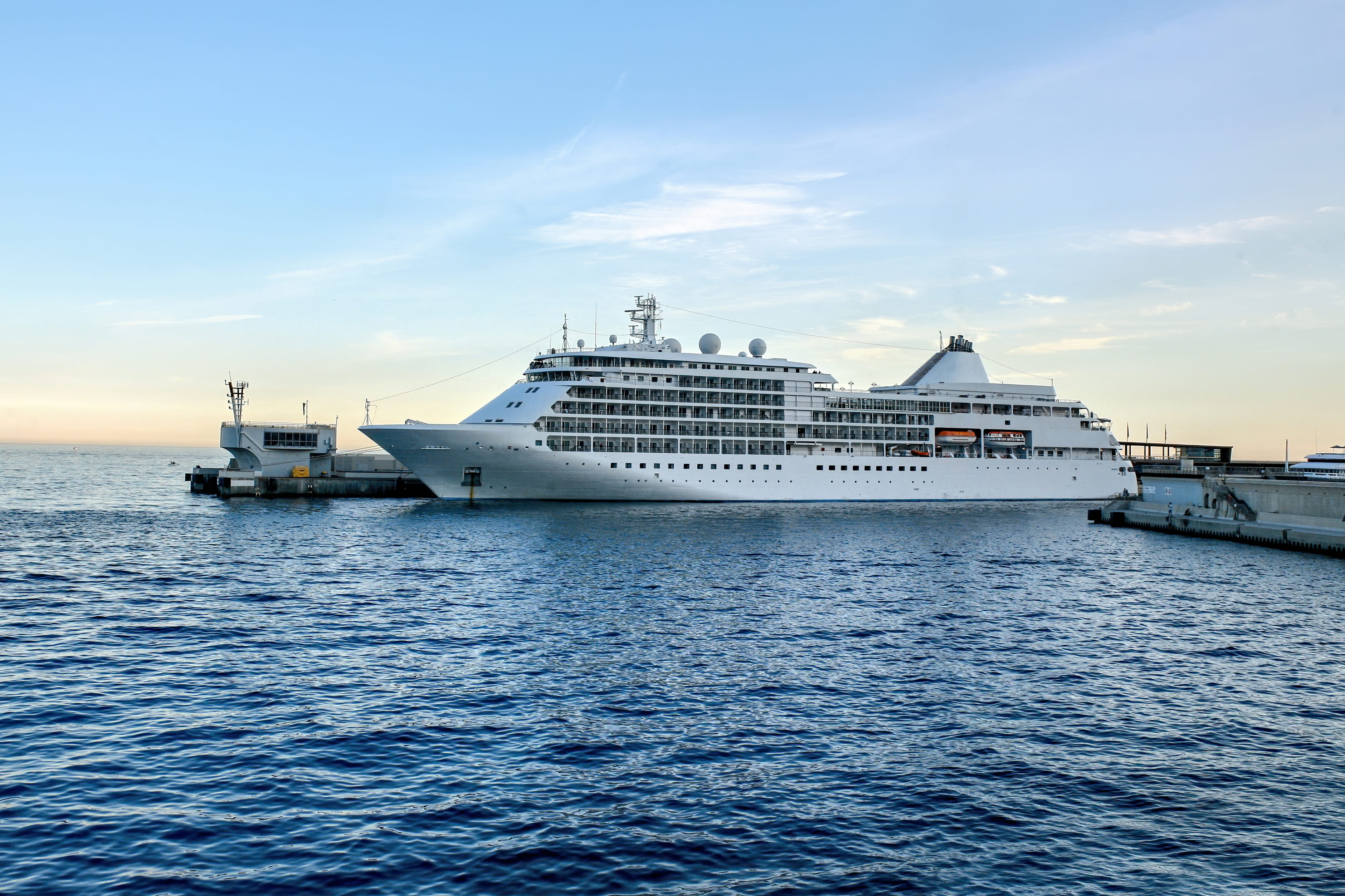 Cruise ship departing Dubai Port with Burj Al Arab skyline in background
